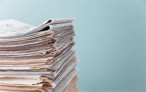 Premium Photo Pile Of Newspapers On White Background