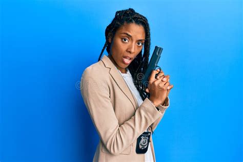 African American Police Woman Holding Gun In Shock Face Looking