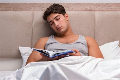 Premium Photo | Man reading book in the bed