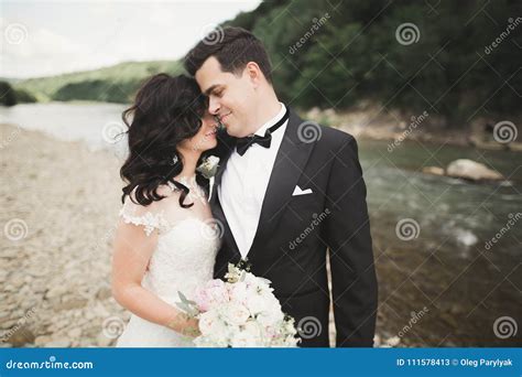 Elegant Stylish Happy Brunette Bride And Gorgeous Groom On The