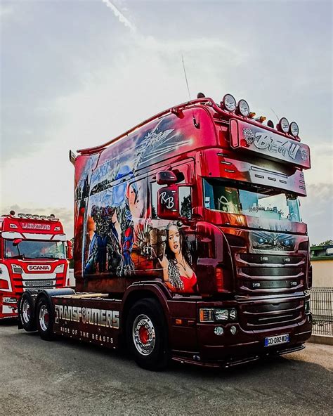 Two Large Trucks Are Parked Next To Each Other