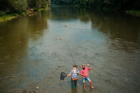 Premium Photo Two Men Friends Fisherman Fishing On River Old Father