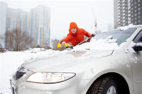 Premium Photo Guy Cleans The Snow With A Brush From The Car A Man