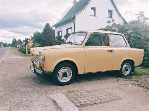 Premium Photo Vintage Car Parked On Road By House Against Cloudy Sky