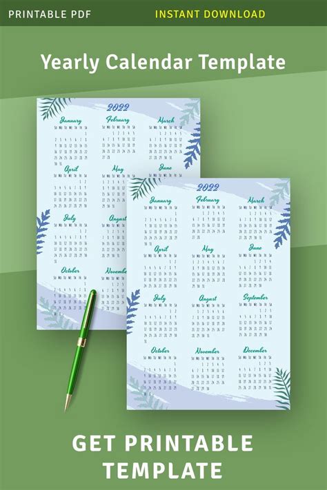 Two Blank Calendars With Green Leaves On Them And A Pen Next To The One