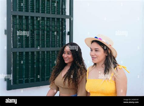 Two Latina Friends Holding Hands In The Street Stock Photo Alamy