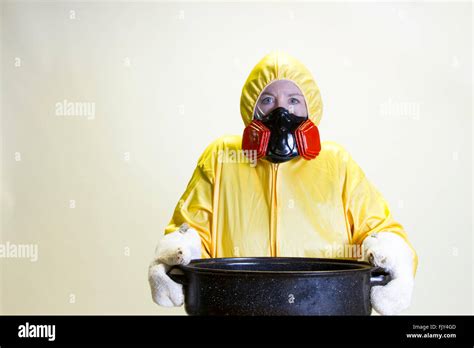 Mature Woman In Yellow Hazmat Suit Holding Roasting Pan Stock Photo Alamy