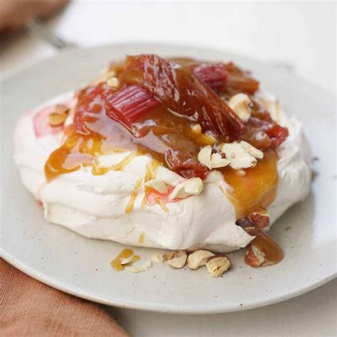 A Dessert With Fruit And Nuts On A White Plate