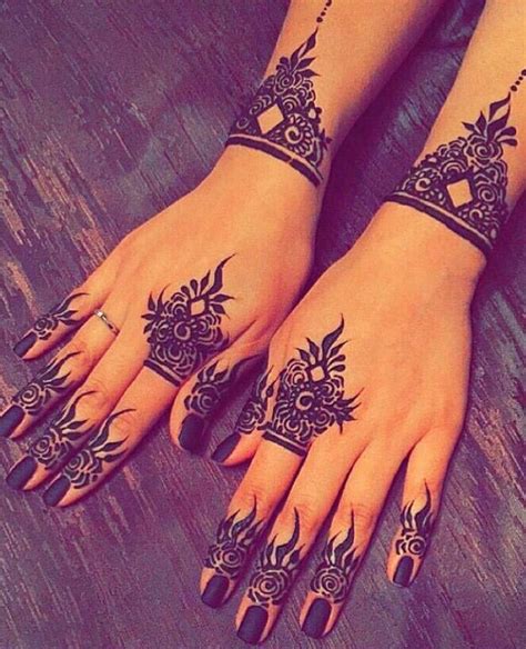 Two Hands With Henna Tattoos On Them