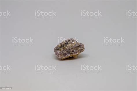 Closeup Of A Bornite Mineral On A Gray Background Stock Photo