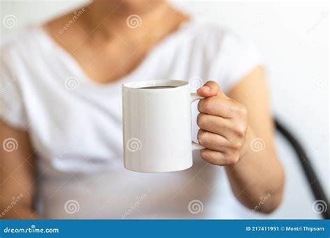 Asian Woman Hand Holding A White Cup Of Mug Of Hot Black Americano