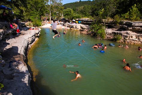 A Swimmer Leaps Off The Cliff At Bull Creek District Park Known As