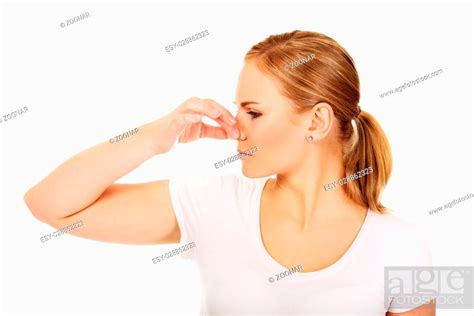 Young Woman Holding Her Nose Because Of A Bad Smell Stock Photo