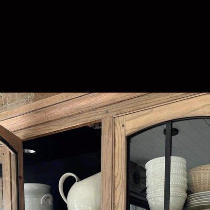 An Old China Cabinet With Dishes And Cups In It S Glass Front Doors Is