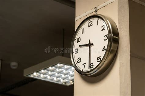 One Single Simple Industrial Clock In A Factory Hall Or A Corporate