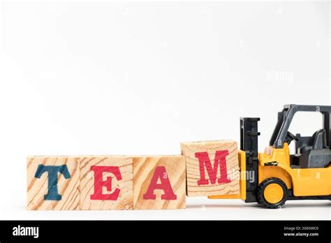 Toy Forklift Hold Letter Block M To Complete Word On Team White