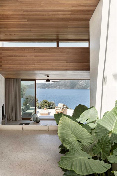 A Modern Greek Villa Built Into the Cliffside Overlooking the Sea