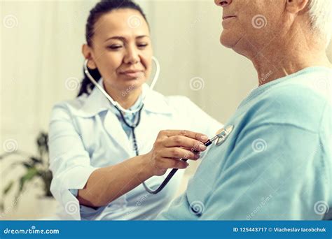 Close Up Of Female Doctor Using Stethoscope During Checkup Stock Image