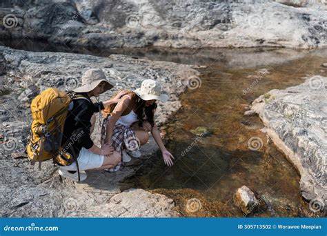 Happy Lgbt Lesbian Couple Travelers Hiking With Backpacks In Waterfall Trail Lgbt Lesbian