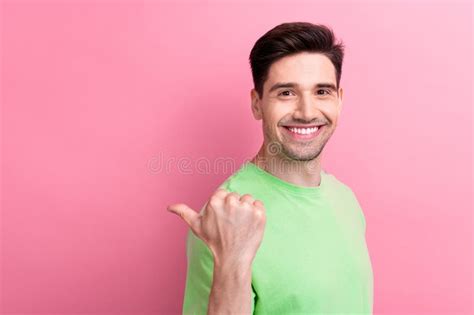 Photo Of Young Cheerful Smiling Guy Dressed Green T Shirt Pointing Finger Empty Space Brand