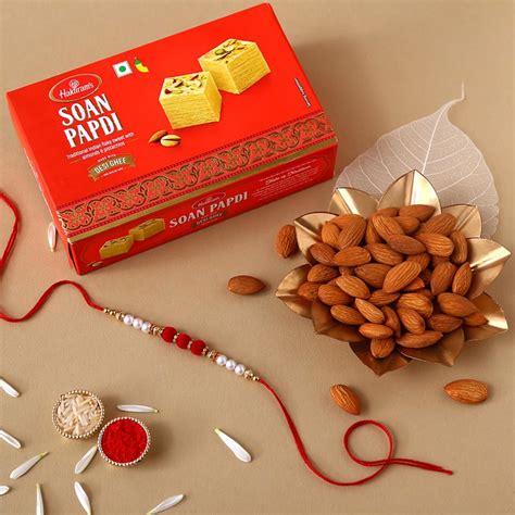 Send White Pearl And Velvet Beads Rakhi With Grams Soan Papdi And