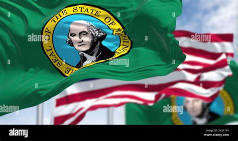 The Washington State Flag Waving Along With The National Flag Of The