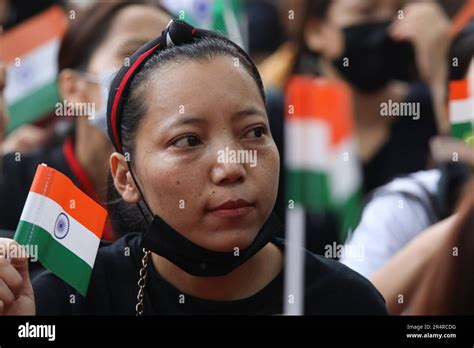 A Woman Belonging To Manipur Kuki Tribe Looks On While Holding An