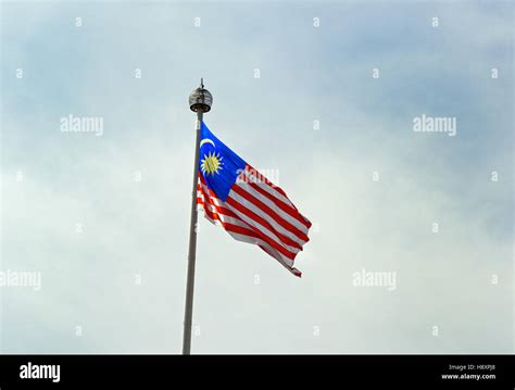 Malaysia national flag on blue sky background Stock Photo - Alamy