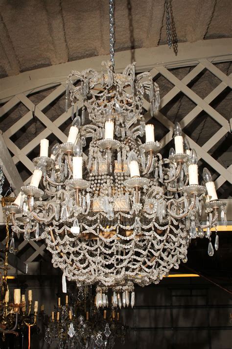 Pair of Italian gilded iron and crystal chandeliers.