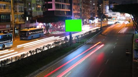 Time Lapse Of Blank Billboard With A Green Screen On Night Street With