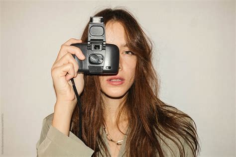 Beautiful Dark Haired Girl Makes A Party Photo On An Old Camera By Stocksy Contributor Karyna