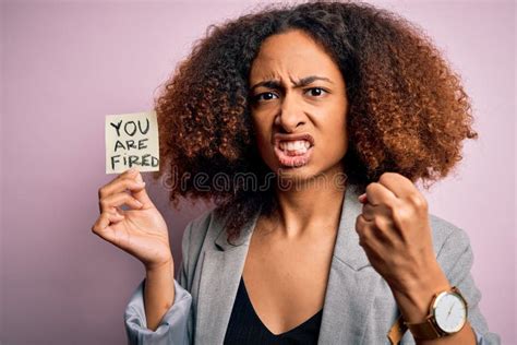 Young African American Woman With Afro Hair Holding Paper With You Are Fired Message Annoyed And