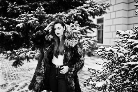 Free Photo Brunette Girl In Green Fur Coat At Winter Day Against Snowy Pine Tree