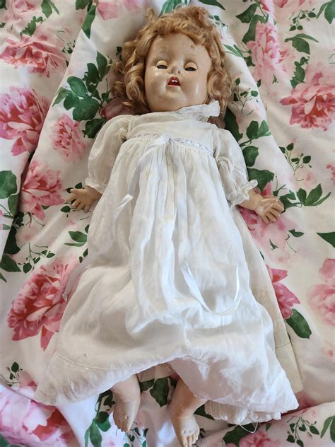 Any information on this composite mama doll? She has two gold barrettes ...