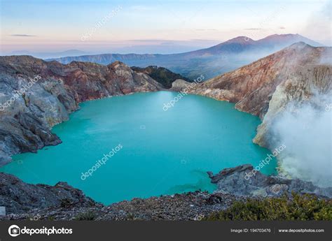 Colorful Ijen volcano crater lake and Raung volcano at the background ...