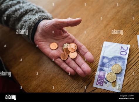 Hand holding coins Stock Photo - Alamy