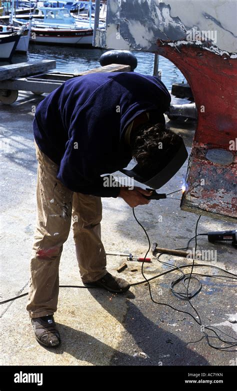 Wielder repairing a fishing boat, Marseille, France Stock Photo - Alamy