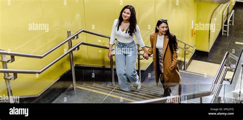 happy girl friends holding hands   stairs stock photo alamy