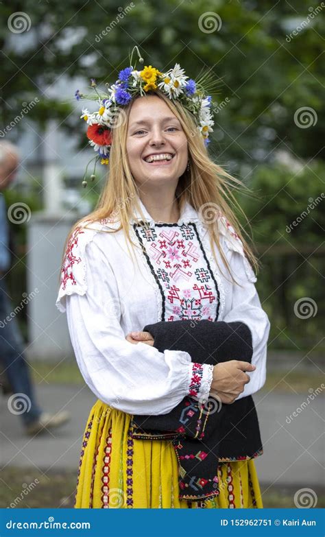 Estonian People In Traditional Clothing Walking The Streets Of Tallinn