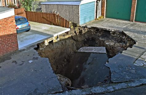 Giant Sinkhole Opens Up In Middle Of Residential Street