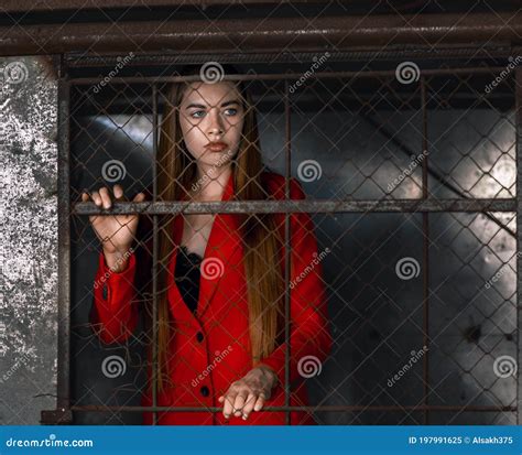 Long Haired Brunette Woman In Red Behind Bars Stock Image Image Of