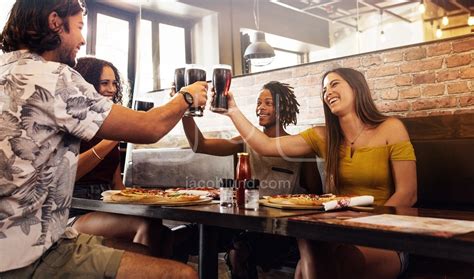 Multi Ethnic Group Of Friends Toasting Soft Drinks At Cafe Jacob Lund