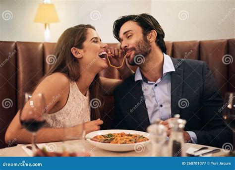 Is This Really Going To Be Our First Kiss A Young Couple Sharing Spaghetti During A Romantic