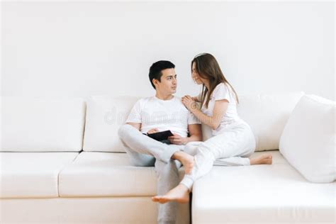 Portrait Of Smiling Cheerful Young Man And Woman Hug On White Living