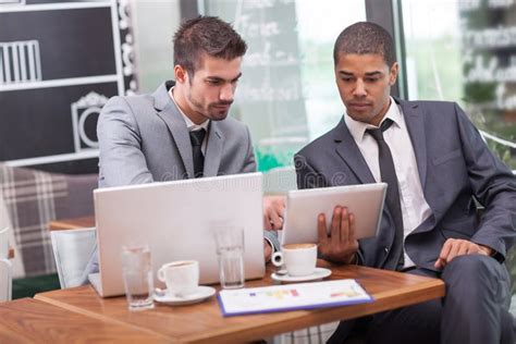 Young Businesspeople Having A Business Meeting At Coffee Shop Stock