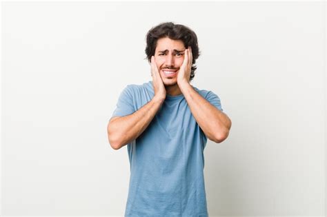 Premium Photo Young Handsome Man Against A White Whining And Crying