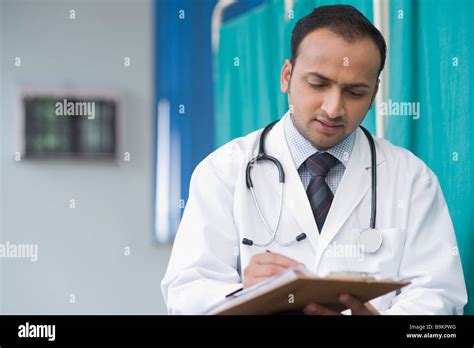 Doctor Writing On A Notepad Stock Photo Alamy