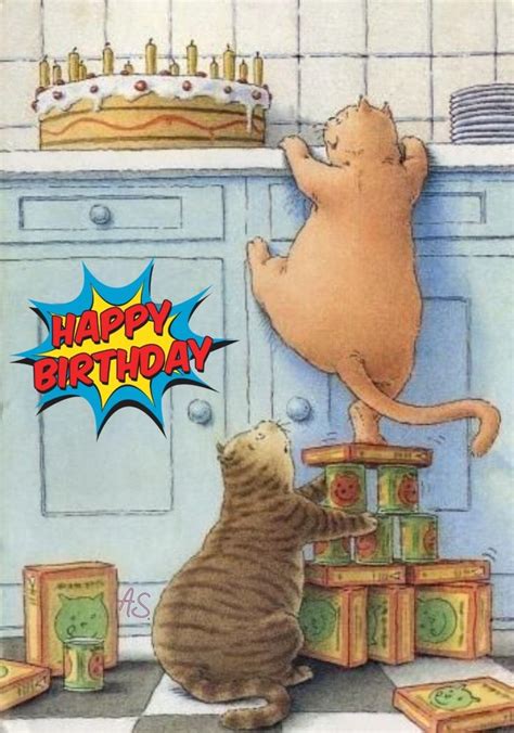 A Cat Is Looking At Another Cat On Top Of Blocks In Front Of A Birthday