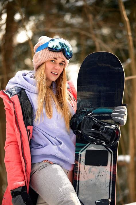 Close Up Portrait Of Snowboarder Woman At Ski Resort Wearing Helmet And