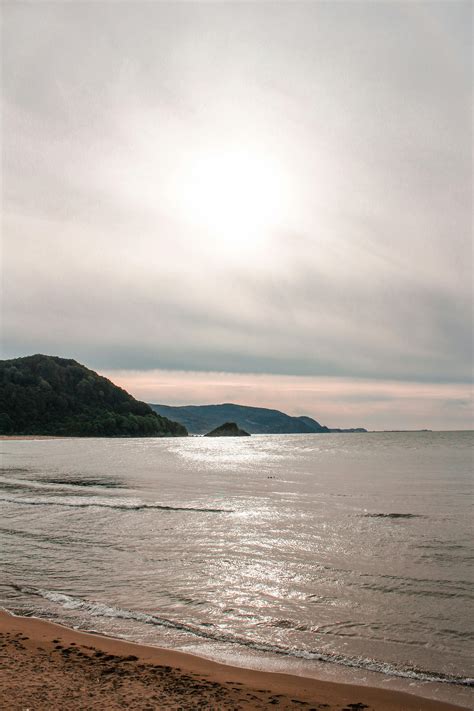 Beautiful Beach With Calm Blue Waters · Free Stock Photo